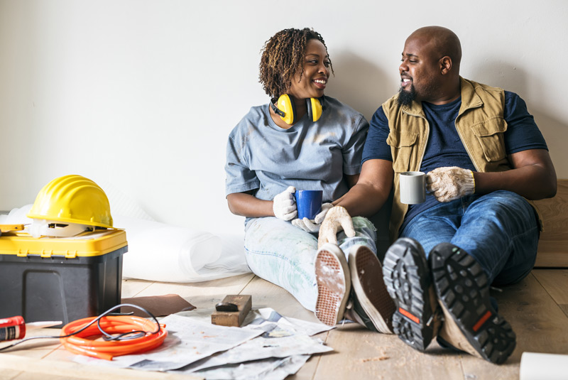 couple sitting rejoicing in home improvements to increase the value of their home.