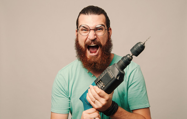 man ferociously holding a power tool - too much? or do we need hand tools? He is very excited about power tools.